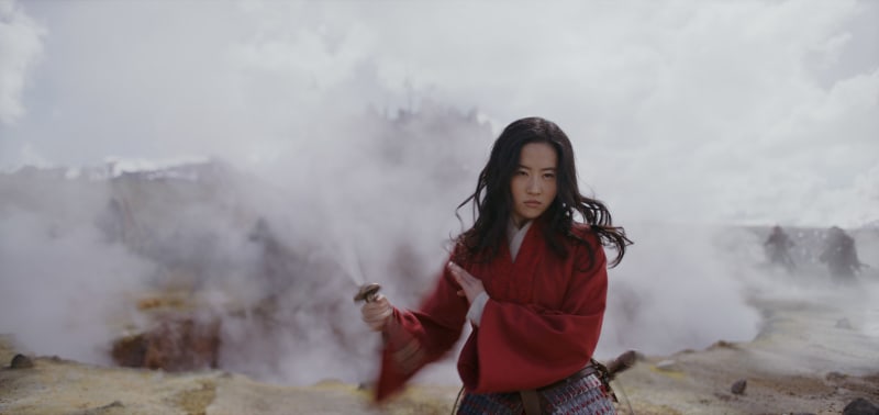 Asian woman standing on a foggy batthfiled, holding a sword.